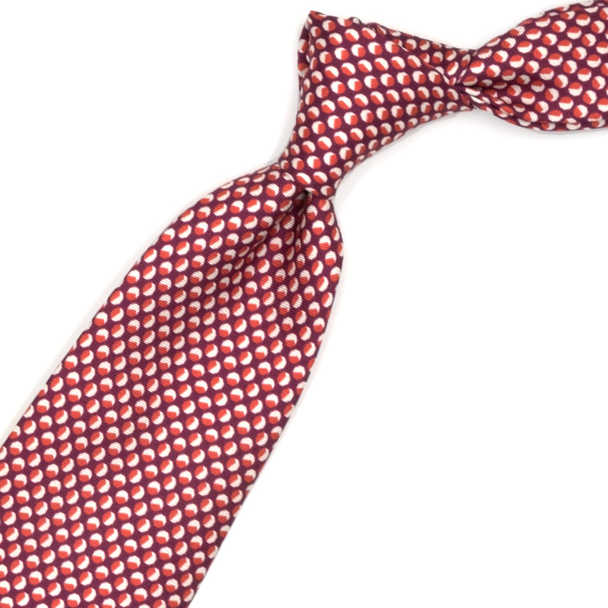 Magenta tie with red and white geometric pattern